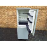 A Swan fridge freezer, approximate height 139 cm x 52 cm x 54 cm.