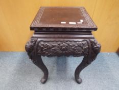 A highly carved Indian occasional table approx 55cm x 42cm x 42cm