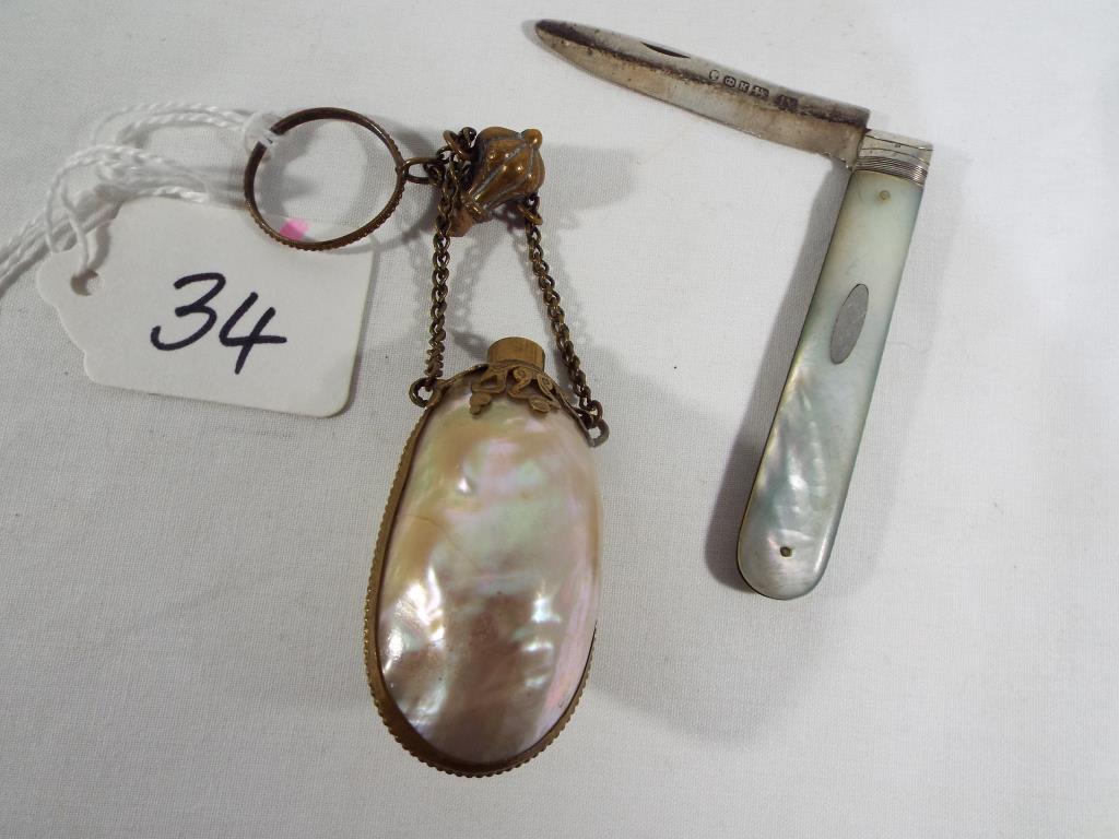 A mid 19th century French Mother of Pearl Chatelaine stoppered perfume bottle with yellow metal