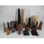 Eighteen decorative carved hard stone items comprising obelisks, pyramids, pillar and similar,