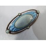 A silver brooch with Guilloche enamel decoration, assay marks for Birmingham 1919,