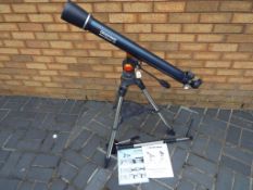 A Celestron Astro Master 70 with tripod stand, instruction manual, lenses,