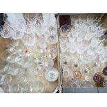 Two boxes containing a large quantity of drinking glasses to include tumblers, flutes,