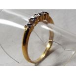 A lady's 9 carat gold 10 point diamond three-stone kiss ring, approx 1.