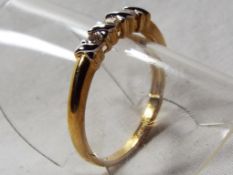 A lady's 9 carat gold 10 point diamond three-stone kiss ring, approx 1.