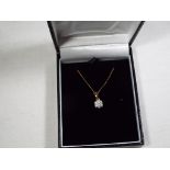 A lady's 9 carat gold 25 point round diamond set cluster pendant, approx 1.