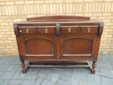 A good quality sideboard with carved decoration with two drawers and cupboards,