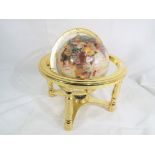 A small semi-precious gemstone terrestrial globe, approximate diameter 15 cm.