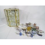 A glass display cabinet containing approximately 25 crystal figures,