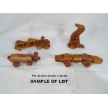A quantity of 28 wooden push-along toys of crocodiles, car transporters,