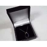 A lady's 9 carat white gold blue sapphire tear-drop pendant and chain, approx 1.