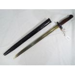 A British 1907 Pattern Bayonet, and Scabbard. The blade is stamped with a crown over "G.R.