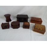 A wooden cigarette box and six wooden trinket boxes of varying size and styles