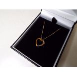 A lady's 9 carat gold 10 point diamond set heart pendant, approx 1.