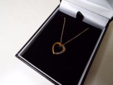 A lady's 9 carat gold 10 point diamond set heart pendant, approx 1.
