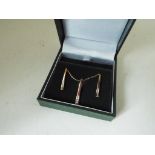 A lady's 9 carat gold 20 point diamond stick pendant and earrings set, approx 2.