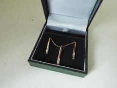 A lady's 9 carat gold 20 point diamond stick pendant and earrings set, approx 2.