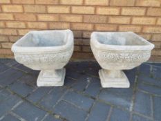 Garden Stoneware - two square ornate stone urns decorated with roses.