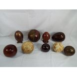 Nine decorative eggs and spheres comprising ceramic, wooden,