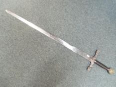 A large sword marked to the pommel Excalibur King Arthur, decorated with dragons to the cross guard,