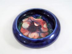 Moorcroft Pottery - a small Moorcroft Pottery bowl decorated with Anemone on a blue ground