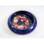 Moorcroft Pottery - a small Moorcroft Pottery bowl decorated with Anemone on a blue ground