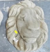 A stone wall plaque in the form of a lions head