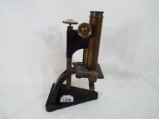 A brass microscope by R & J Beck of London - This lot MUST be paid for and collected,