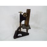 A brass microscope by R & J Beck of London - This lot MUST be paid for and collected,