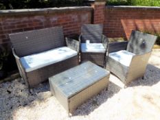 A modern faux rattan cube patio set comprising matching bench seat,