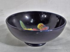 Moorcroft pottery - a small Moorcroft pottery footed bowl decorated with the orchid pattern on a