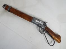 A replica Winchester underlever 'mares leg' rifle with moving underlever action - Est £30 - £50 -