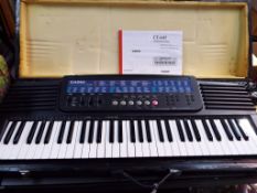 A Casio CT - 647 electronic keyboard set in wooden carry case with instruction manual and power