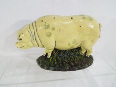 A cast iron doorstop in the form of a pig,