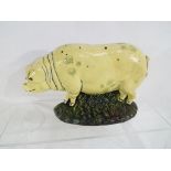 A cast iron doorstop in the form of a pig,