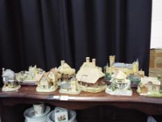 Eleven models of cottages, castles and similar to include Lenox, David Winter,