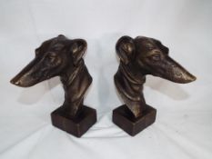 A pair of cast bronzed busts depicting grey hounds,