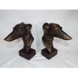 A pair of cast bronzed busts depicting grey hounds,