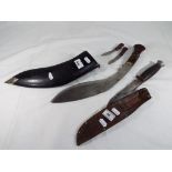 A well maintained Kukri knife with a small knife and sharpener in a wooden leather bound sheath