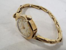 A lady's 9 carat gold cased Rotary wristwatch with yellow metal expanding bracelet stamped .