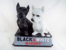 Advertising - a Black & White whisky advertising set depicting an black and white Scotty dogs,