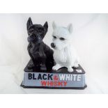Advertising - a Black & White whisky advertising set depicting an black and white Scotty dogs,
