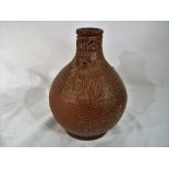 A 17th century dark brown salt glazed stoneware Bellarmine jug / flagon (lacking handle) bearded