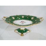 Royal Crown Derby - a large green tazza by Royal Crown Derby with floral and gilt decoration,