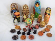 A collection of Russian lacquered dolls, including a Santa and some wooden eggs,