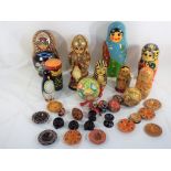 A collection of Russian lacquered dolls, including a Santa and some wooden eggs,