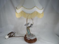 A good quality ceramic table lamp on wooden plinth, the plaque marked R.