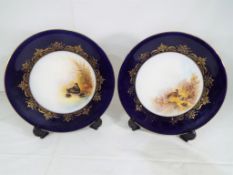 Royal Worcester - a pair of large Royal Worcester plates with blue and gilt rim,