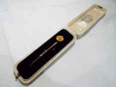 A 14 carat gold, single stone set stick pin, 1.