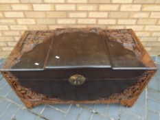 A 20th century African carved wood linen chest, 58 cm x 100 cm x 50 cm,